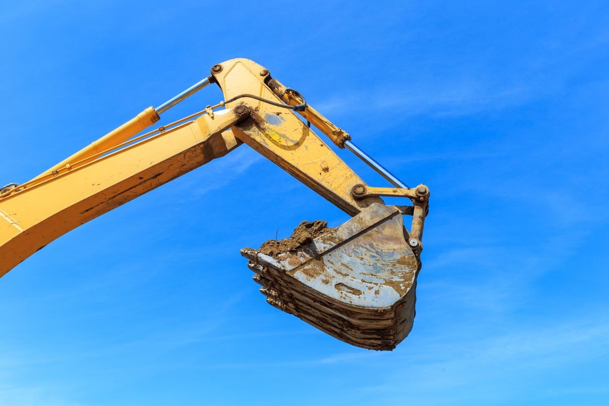 Excavator bucket over the blue Sky