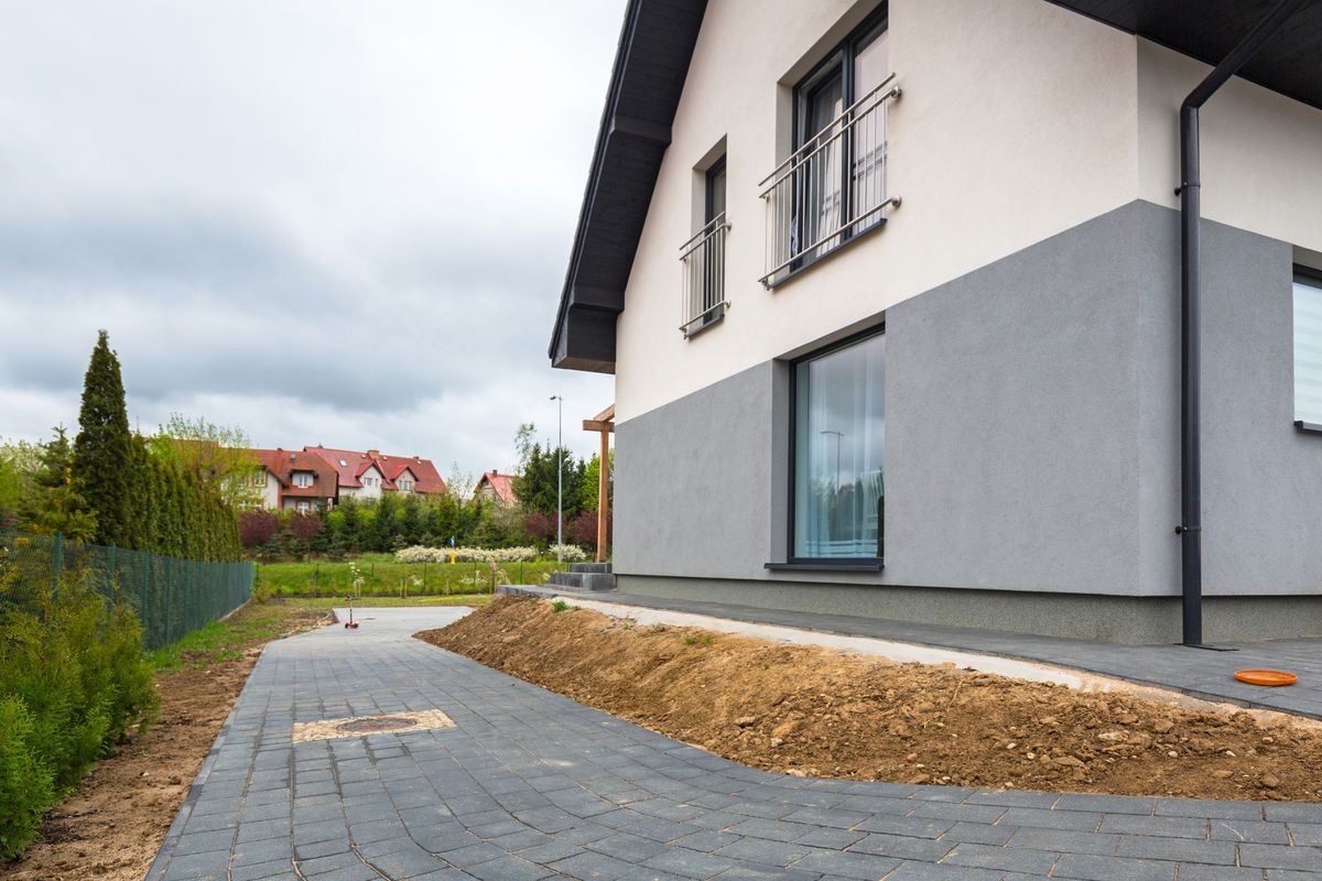 House with new laid concrete paver blocks